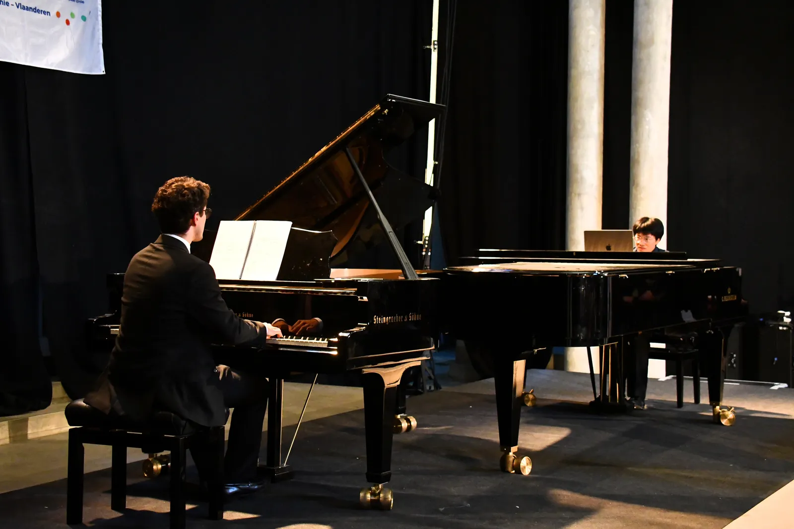 Pianists performing on stage